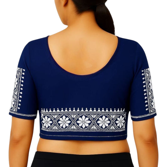 Navy blue blouse with white embroidery on a plain background
