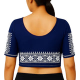 Navy blue blouse with white embroidery on a plain background